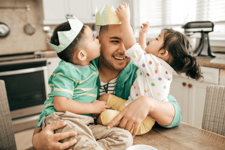 Father playing with two small children