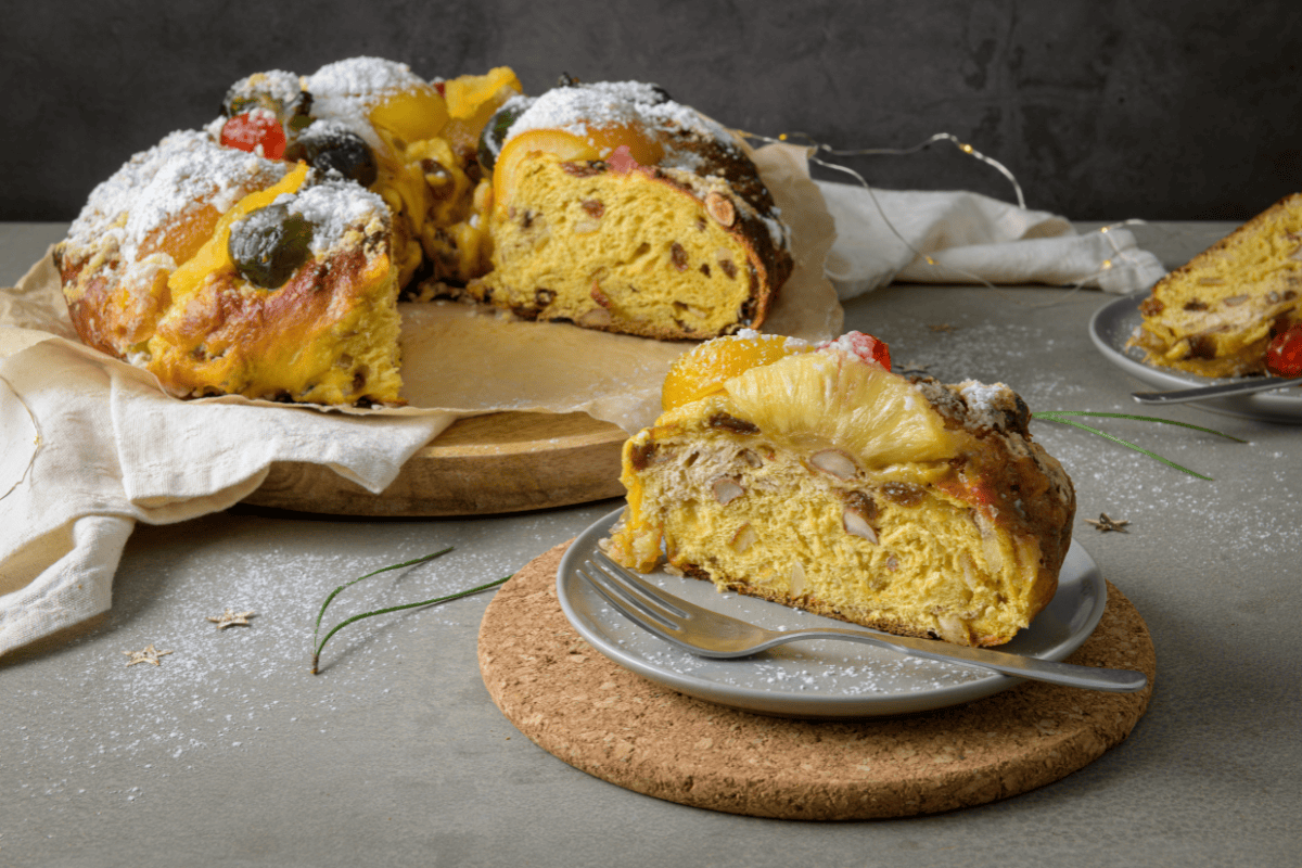 bolo rei with one slice on a plate in front