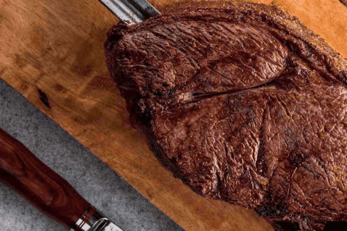 alcatra top sirloin on roasting spit and cutting board